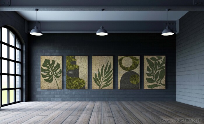 Une galerie spacieuse avec parquet et haut plafond présente cinq œuvres d'art sur le thème de la nature sur un mur de briques grises. Chaque pièce présente divers motifs de feuilles avec des motifs de fond abstraits. Trois suspensions sont suspendues au plafond et de grandes fenêtres laissent entrer la lumière naturelle, mettant en valeur les installations Earth Gagos.